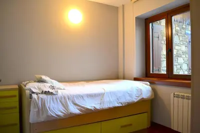 Cama o camas de una habitación en Apartament rústic amb llar de foc by RURAL D'ÀNEU