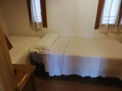 Cama o camas de una habitación en Pequeño adosado de montaña con terraza