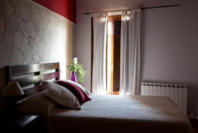 Cama o camas de una habitación en Apartamentos La Morada del Cura