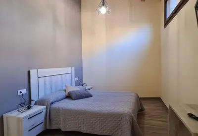 Cama o camas de una habitación en Apartamentos La Era de Pasé
