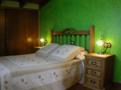 Cama o camas de una habitación en casa rural la pallisa