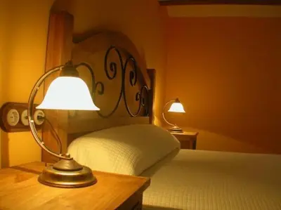 Cama o camas de una habitación en casa rural la pallisa