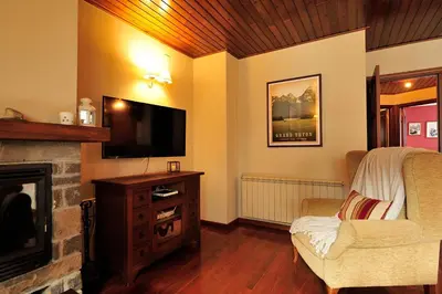 Una televisión o centro de entretenimiento en Cal Berg, Acogedor apartamento en Garòs cerca de Baqueira by Eth Flòc