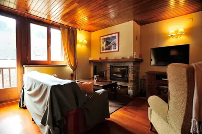 Una televisión o centro de entretenimiento en Cal Berg, Acogedor apartamento en Garòs cerca de Baqueira by Eth Flòc
