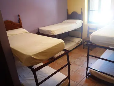 Cama o camas de una habitación en Albergue Las Almunias