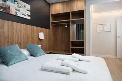 Cama o camas de una habitación en Apartamentos Torre del Reloj