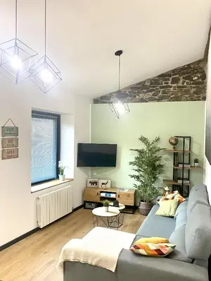Una televisión o centro de entretenimiento en Ático abuhardillado imak Jaca