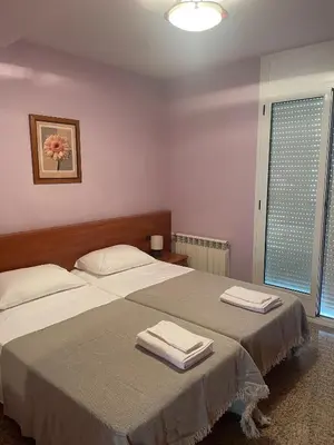 Cama o camas de una habitación en Apartamentos Villa de Ainsa