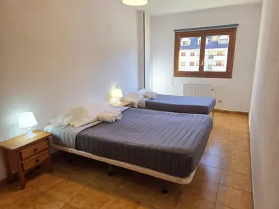 Cama o camas de una habitación en Apartamentos Villanua 3000