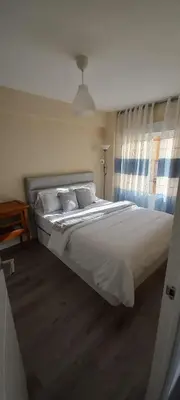 Cama o camas de una habitación en Apartamento cerca del Pilar