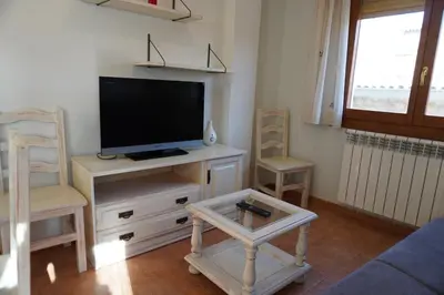 Una televisión o centro de entretenimiento en Apartamentos Casa DOMENC