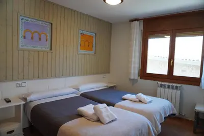 Cama o camas de una habitación en Apartamentos Casa DOMENC