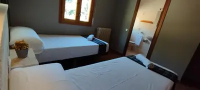 Cama o camas de una habitación en Casa Pirineus - Alojamiento rural & Alquiler de esquís - SKI Pirineus
