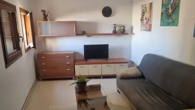 Una televisión o centro de entretenimiento en Apartamento Torre Gótica
