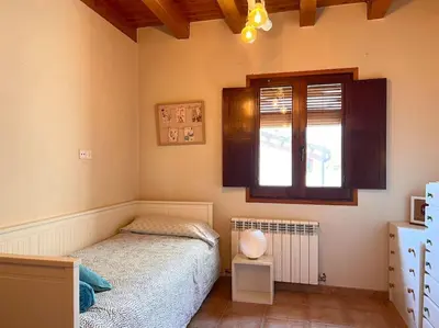 Cama o camas de una habitación en Casa Martinach - L'Amfitriona