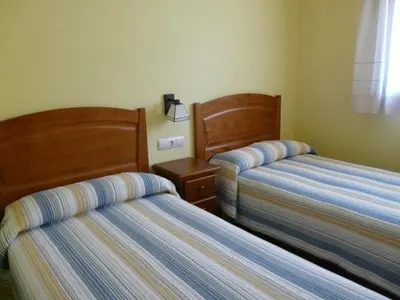 Cama o camas de una habitación en Complejo Turístico Bielsa Hotel y camping