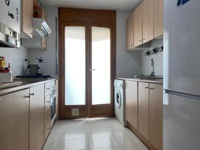 Una cocina o zona de cocina en Apartamentos Alcañiz, Blanca