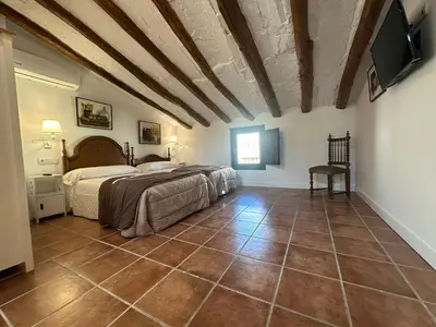Cama o camas de una habitación en casa rural las mariposas