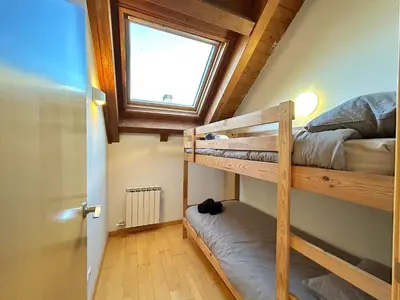 Cama o camas de una habitación en Àtic lluminós i familiar by RURAL D'ÀNEU