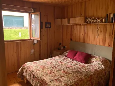 Cama o camas de una habitación en La casita de madera