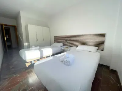Cama o camas de una habitación en Apartamentos Zaragoza Suites El Pilar 3000