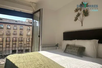 Cama o camas de una habitación en Dos Torres La Dulcería - Jacuzzi y vistas en el corazón de Zaragoza