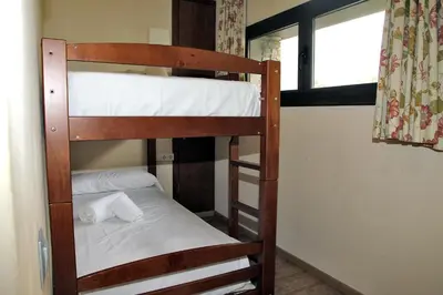 Cama o camas de una habitación en Aparthotel La Vall Blanca