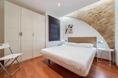 Cama o camas de una habitación en Hauzify I Apartaments La Plaça