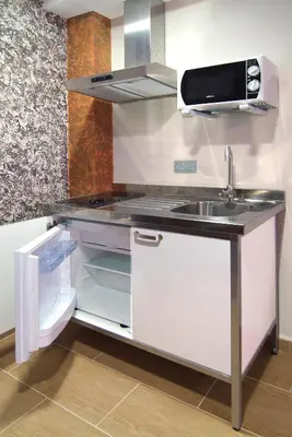 Una cocina o zona de cocina en Apartahotel La Corrala