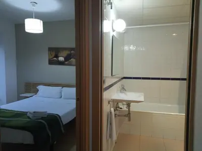 Cama o camas de una habitación en Apartamentos Zaragoza Coso