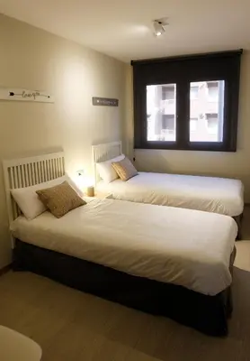 Cama o camas de una habitación en Apartamentos Real Lleida