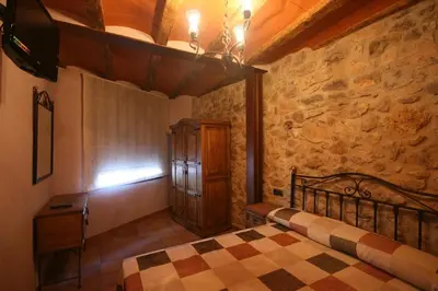 Cama o camas de una habitación en Casa Rural Cal Puyo