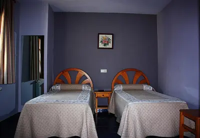 Cama o camas de una habitación en Hostal Casa Lacreu