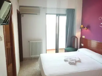 Cama o camas de una habitación en Hostal Jaime I