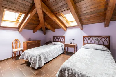 Cama o camas de una habitación en Casa Dieste Apartamentos Turísticos en Boltaña