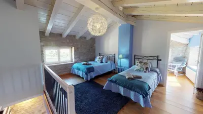 Cama o camas de una habitación en Casa Rural La Abadia-Apartamentos