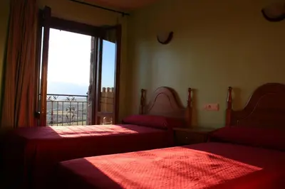 Cama o camas de una habitación en El Churrón