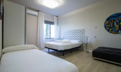 Cama o camas de una habitación en RuralSuite Hotel Apartamentos