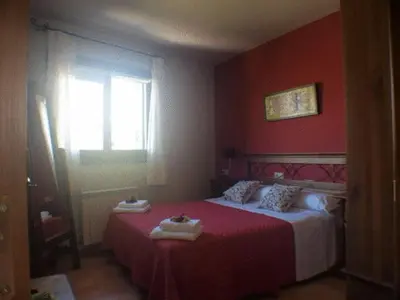 Cama o camas de una habitación en Apartamentos Pirineos Ordesa