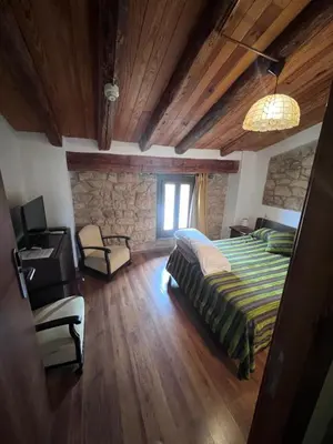Cama o camas de una habitación en La Garbinada Hotel