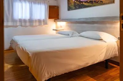 Cama o camas de una habitación en Hostal Casa Palmira