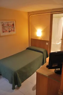 Cama o camas de una habitación en Hotel Goya