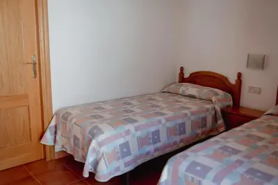 Cama o camas de una habitación en El Portal de la Irene - Apartamentos Rurales