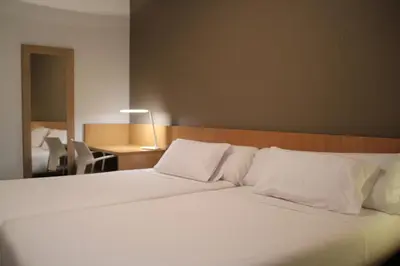 Cama o camas de una habitación en Hostal Abodi