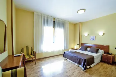 Cama o camas de una habitación en Hotel Ciutat de Tarrega
