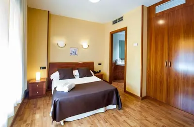 Cama o camas de una habitación en Hotel Ciutat de Tarrega