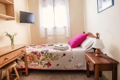 Cama o camas de una habitación en Apartamentos Maribel