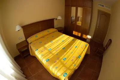 Cama o camas de una habitación en Apartamentos Turmo