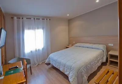 Cama o camas de una habitación en Hotel Jardí Apartaments