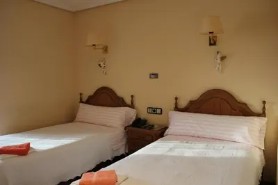 Cama o camas de una habitación en Hostal Casa Perico